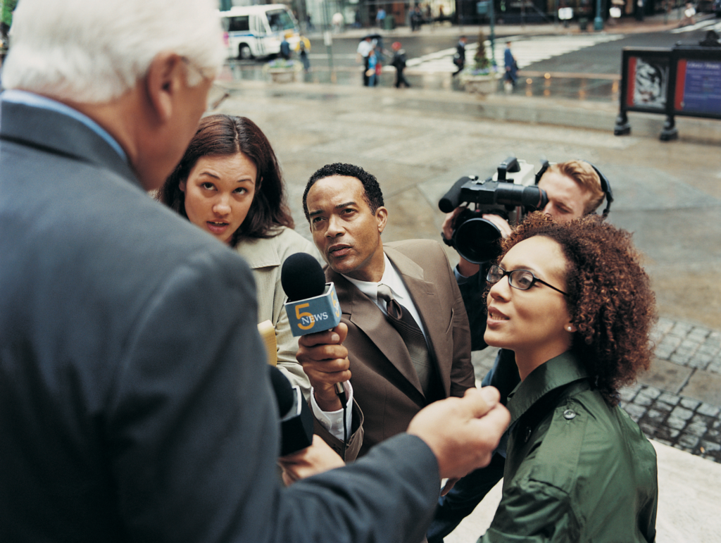 “News Reporters and a TV Cameraman” by Digital Vision is licensed under CC BY 2.0