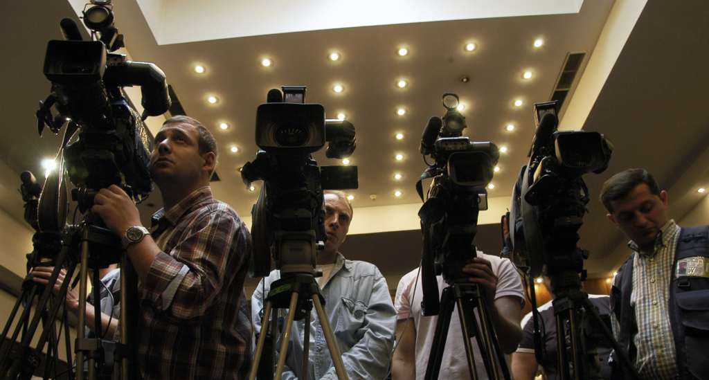 “Camera crews at the joint Press Conference given by the Congress and the ODIHR” by Kober (talk) is licensed under CC BY 2.0